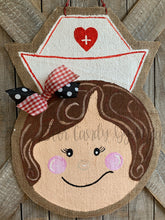 Load image into Gallery viewer, nurse door hanger with nurse hat and red and black bow