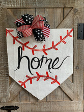 Load image into Gallery viewer, baseball home plate door hanger with hand-lettered home and black and red bow