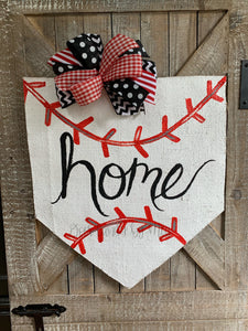 baseball home plate door hanger with hand-lettered home and black and red bow