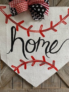 baseball home plate door hanger with hand-lettered home and black and red bow