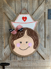 Load image into Gallery viewer, nurse door hanger with nurse hat and red and black bow